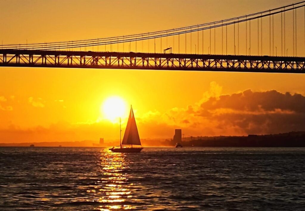 sunset sailboat lisbon