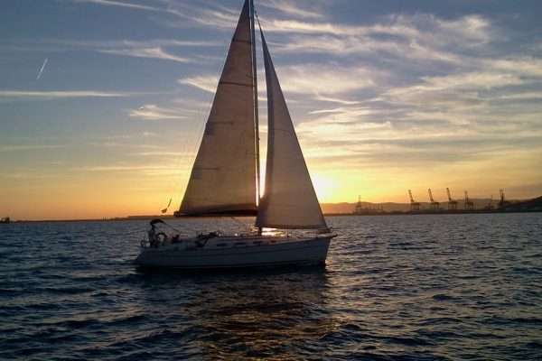 Sailing boat against the sunset in Barcelona