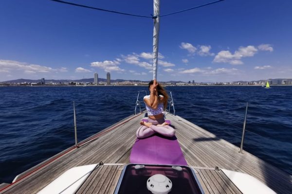 Yoga pose on sailing boat in Barcelona