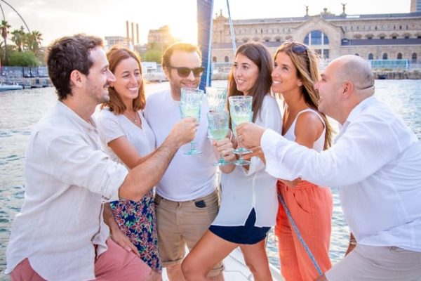 People celebrating with drinks on. a sailing boat in Barcelona